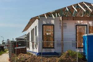 a house under construction with a fence around it